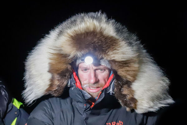 A musher with a bright headlamp