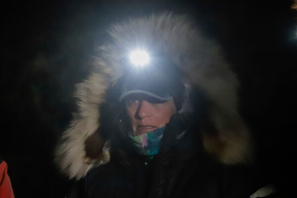 A musher with a bright headlamp