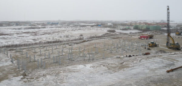 A view from above of a lot on the tundra where preliminary school construction is underway