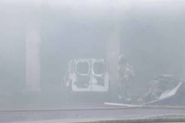 thick smoke with barely visible firefighter and truck