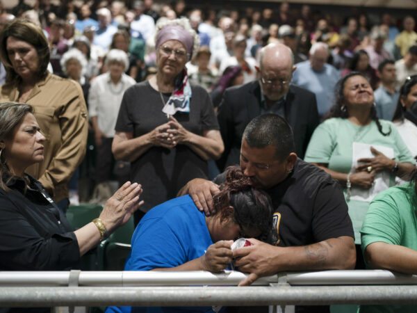 People mourn during a prayer vigil