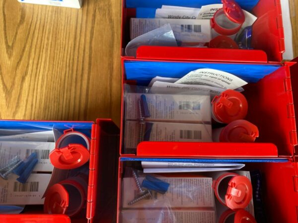 A photo looking down into red boxes containing overdose prevention kits